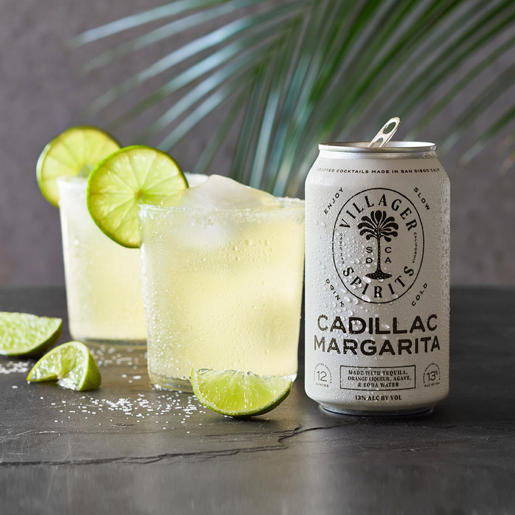 Craft made Villager Spirits Cadillac Margaritas garnished with fresh limes and a salted rim.