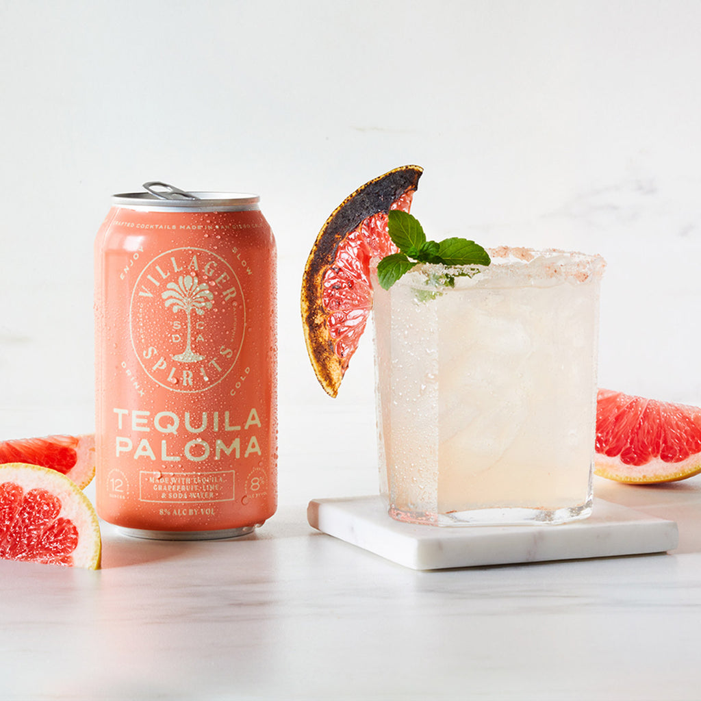 Premium craft cocktail made with Villager Spirits Tequila Paloma garnished with burnt grapefruit, fresh mint and a salted rim.