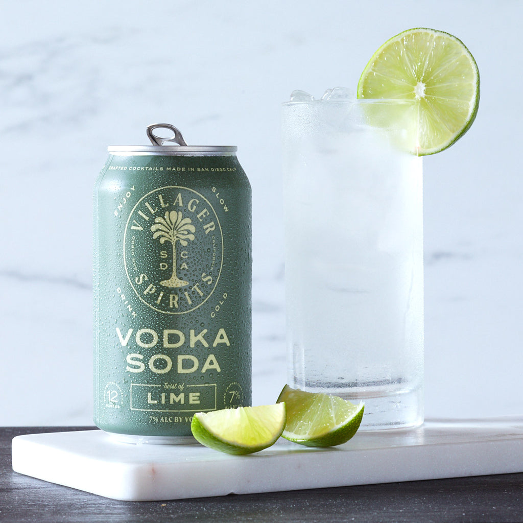 Villager Spirits Vodka Soda Twist of Lime cocktail in a tall glass garnished with a slice of fresh lime.