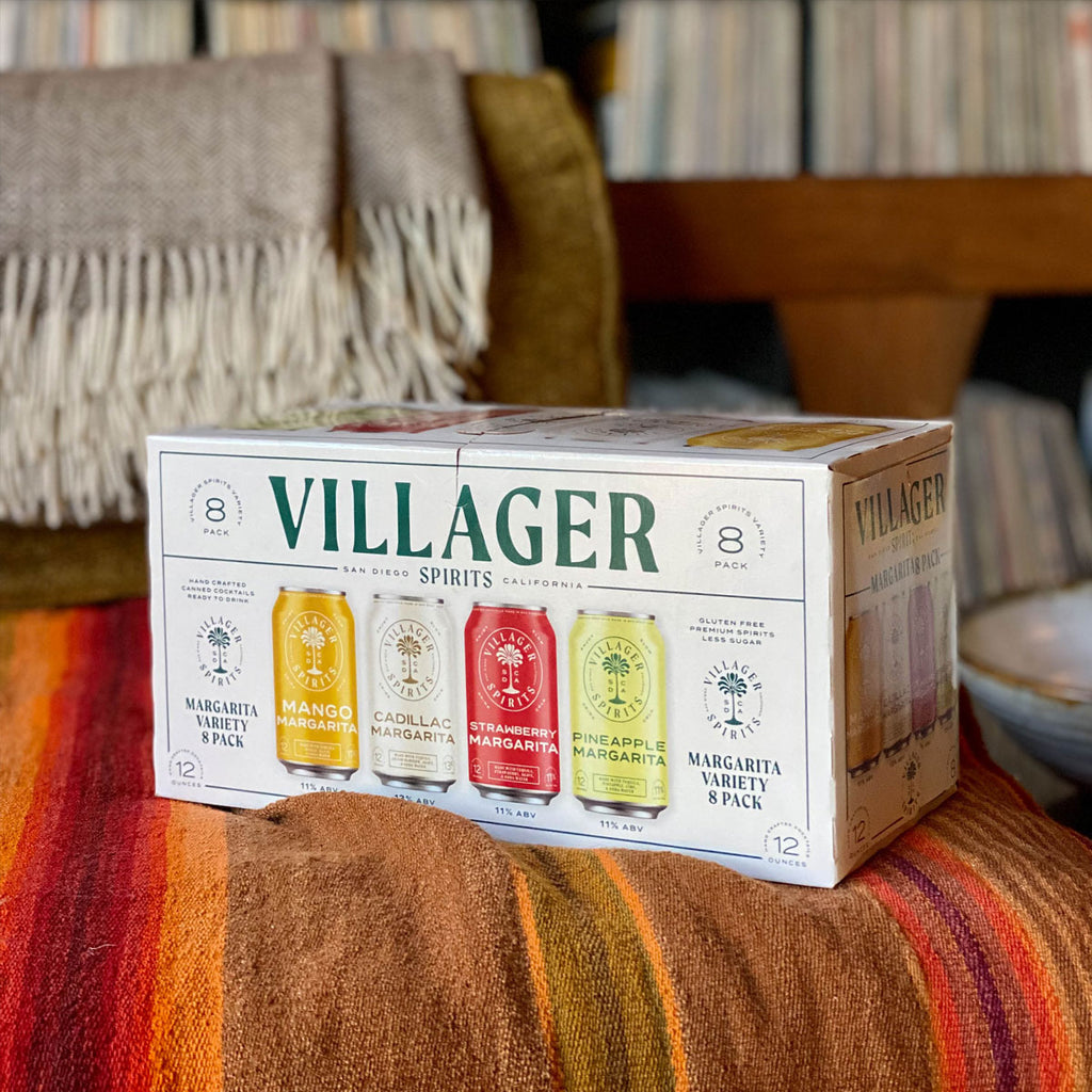 Villager Spirits Margarita Variety 8 Pack sitting on a colorful stripped blanket